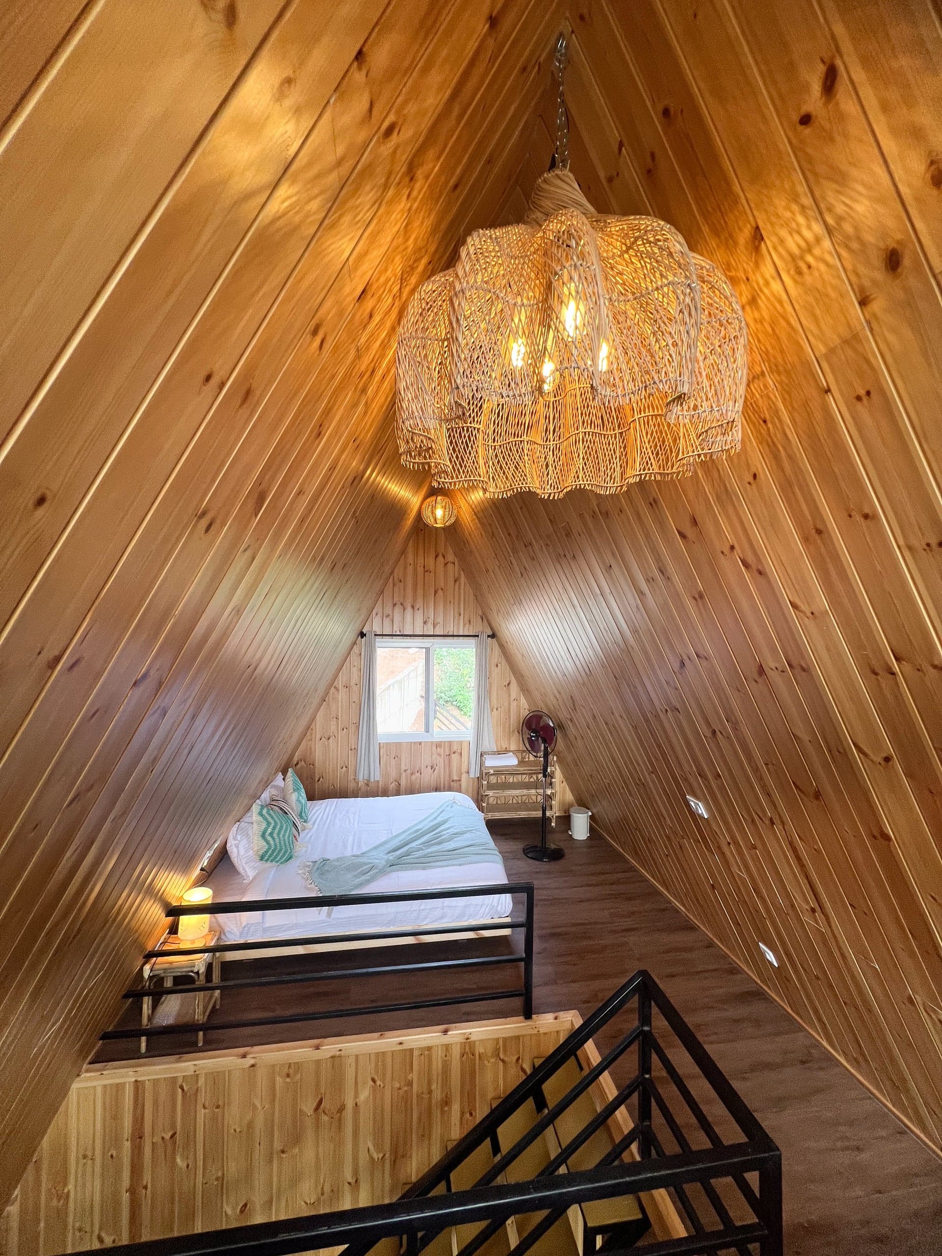 Loft bed beneath the woven chandelier