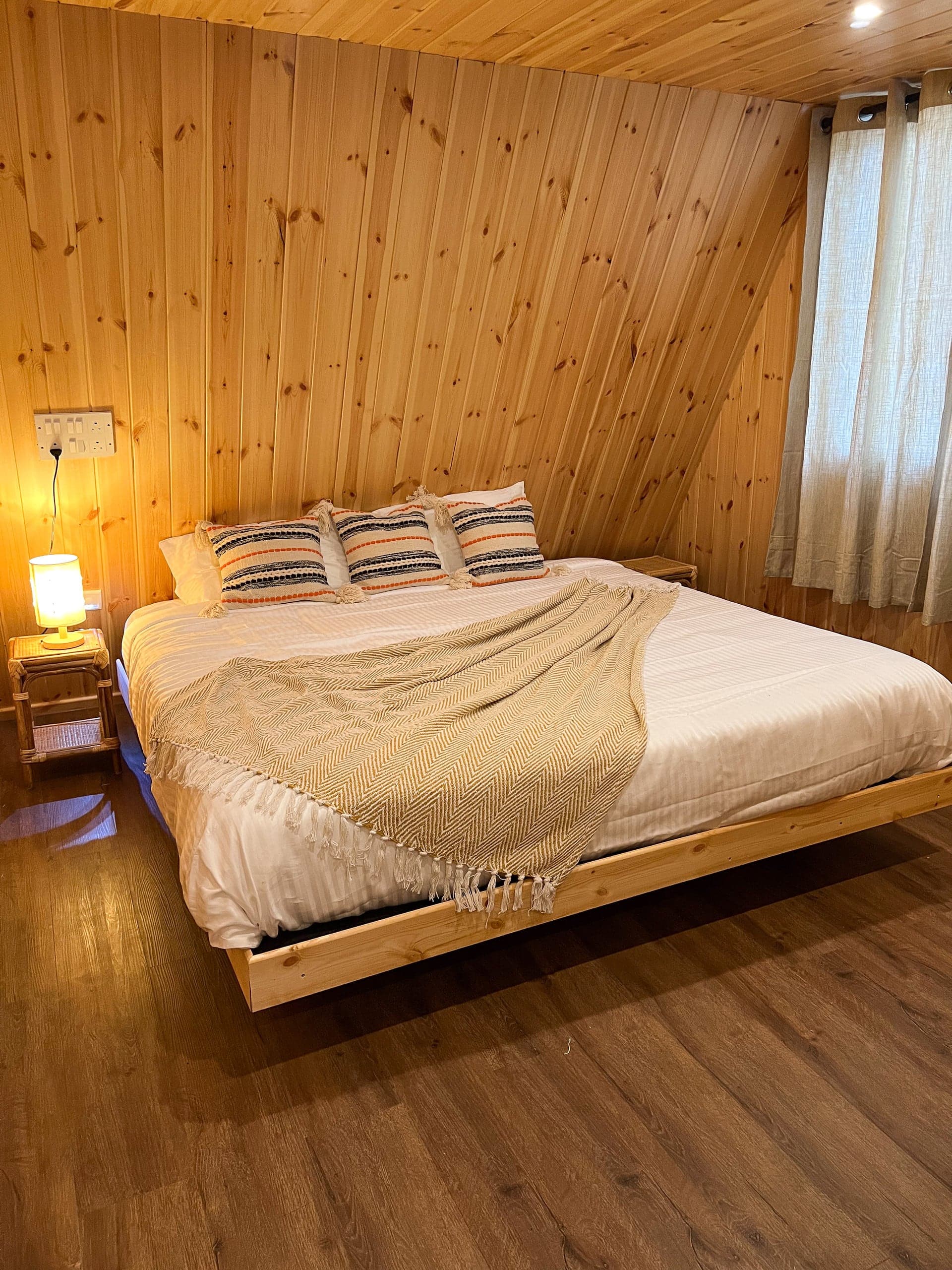 Pine bedroom in warm lamplight